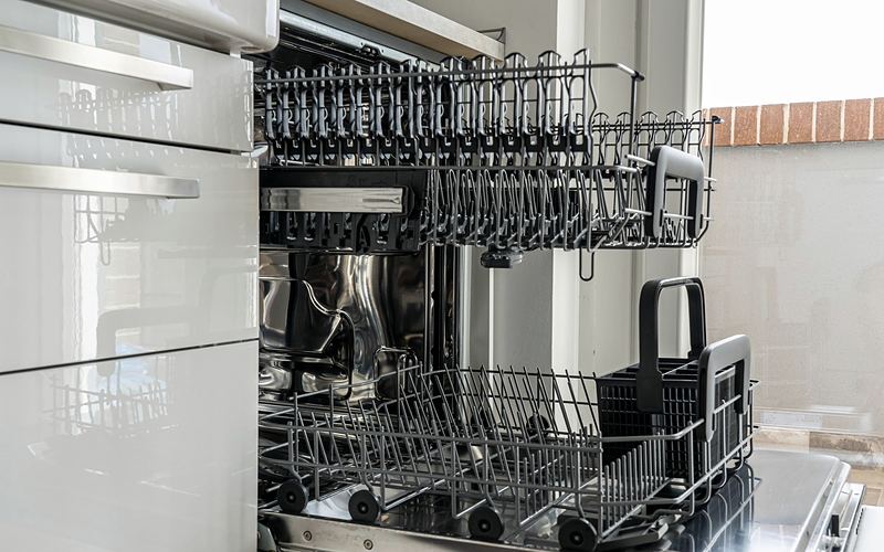 Open dishwasher with the upper and lower racks pulled out